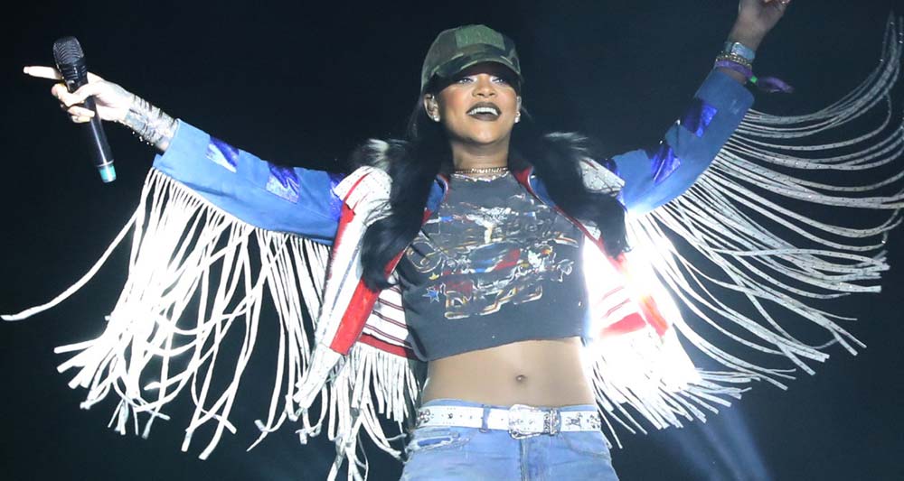 Rihanna on stage at Coachella sporting a baseball cap